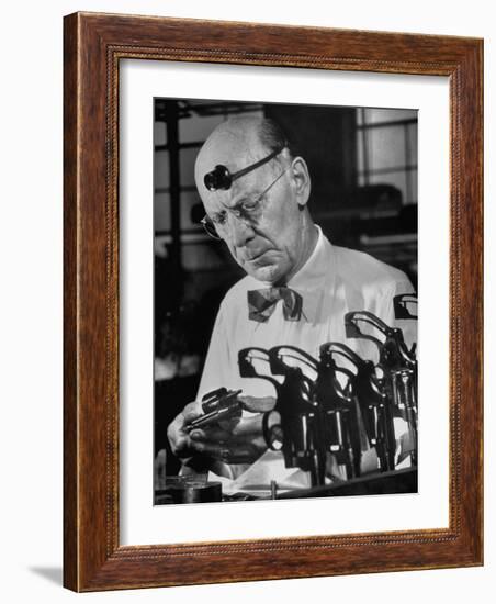 Pistol Engraver Harry Jarvis Disassembling Revolver at Smith and Wesson's Gunmaking Plant-Margaret Bourke-White-Framed Photographic Print