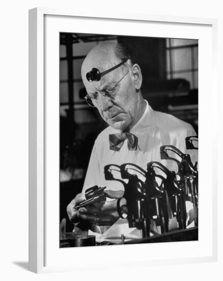 Pistol Engraver Harry Jarvis Disassembling Revolver at Smith and Wesson's Gunmaking Plant-Margaret Bourke-White-Framed Photographic Print