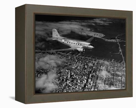 Plane Flying over a City from a Story Concerning United Airlines-Carl Mydans-Framed Premier Image Canvas