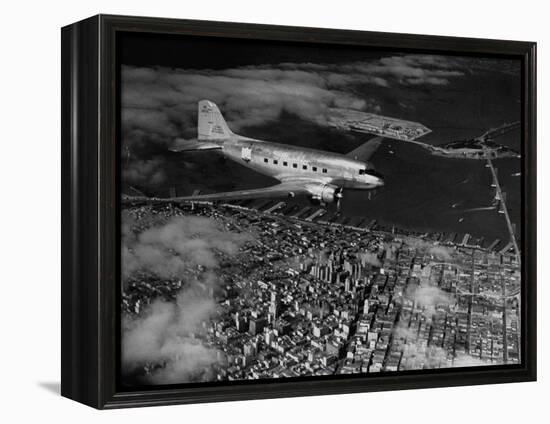 Plane Flying over a City from a Story Concerning United Airlines-Carl Mydans-Framed Premier Image Canvas