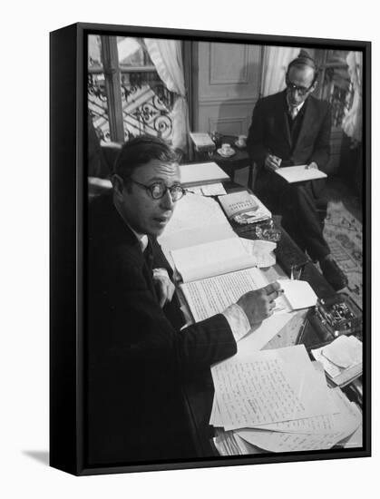 Playwright Jean Paul Sartre at His Desk as Artist Saul Steinberg Sketches at Sartre's Home in Paris-Gjon Mili-Framed Premier Image Canvas