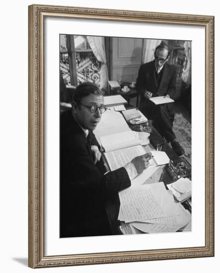 Playwright Jean Paul Sartre at His Desk as Artist Saul Steinberg Sketches at Sartre's Home in Paris-Gjon Mili-Framed Premium Photographic Print