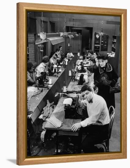 Playwright Paddy Chayefsky Sitting at Typewriter in Garment Factory With Workers on Sewing Machines-Michael Rougier-Framed Premier Image Canvas