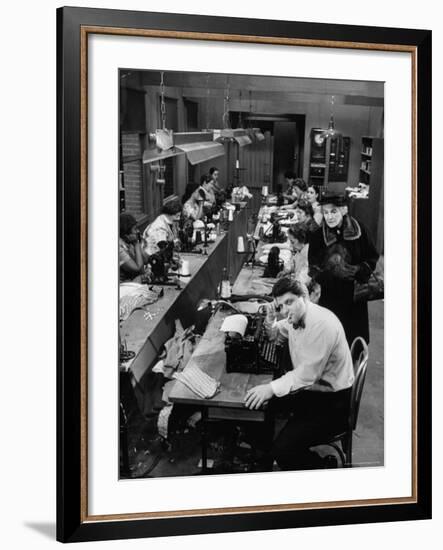 Playwright Paddy Chayefsky Sitting at Typewriter in Garment Factory With Workers on Sewing Machines-Michael Rougier-Framed Premium Photographic Print