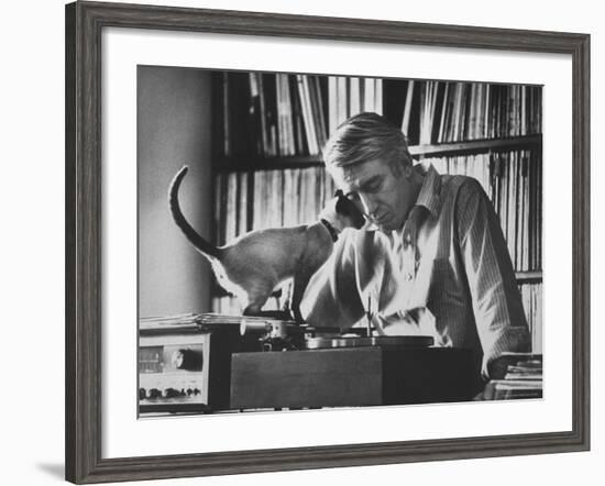 Poet Rod McKuen Playing Record on Stereo Set While Pet Siamese Cat Nuzzles His Face Affectionately-Ralph Crane-Framed Premium Photographic Print