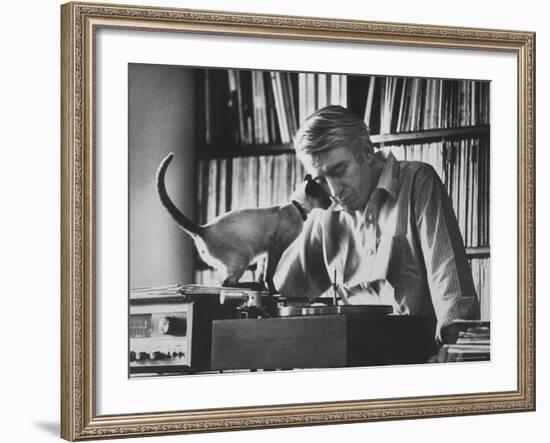 Poet Rod McKuen Playing Record on Stereo Set While Pet Siamese Cat Nuzzles His Face Affectionately-Ralph Crane-Framed Premium Photographic Print