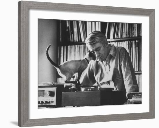 Poet Rod McKuen Playing Record on Stereo Set While Pet Siamese Cat Nuzzles His Face Affectionately-Ralph Crane-Framed Premium Photographic Print