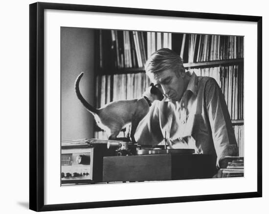 Poet Rod McKuen Playing Record on Stereo Set While Pet Siamese Cat Nuzzles His Face Affectionately-Ralph Crane-Framed Premium Photographic Print