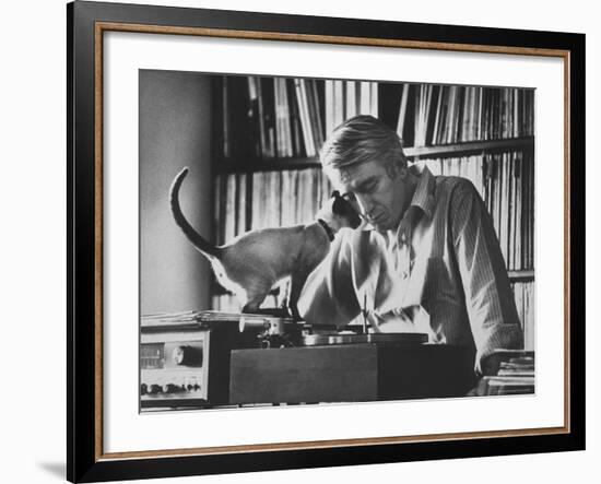 Poet Rod McKuen Playing Record on Stereo Set While Pet Siamese Cat Nuzzles His Face Affectionately-Ralph Crane-Framed Premium Photographic Print