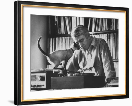 Poet Rod McKuen Playing Record on Stereo Set While Pet Siamese Cat Nuzzles His Face Affectionately-Ralph Crane-Framed Premium Photographic Print