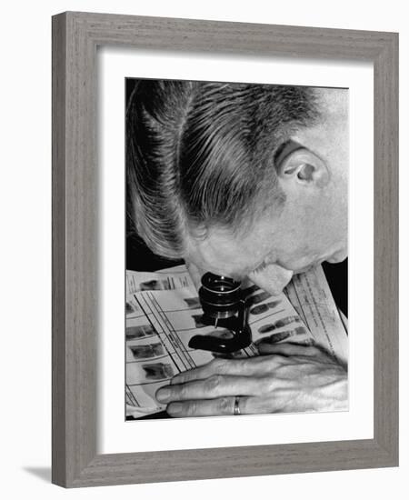 Police Investigator Examining a Set of Fingerprints-Carl Mydans-Framed Photographic Print