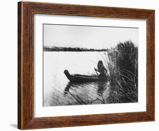 Pomo Indian Poling His Boat Made of Tule Rushes Through Shallows of Clear Lake, Northen California-Edward S^ Curtis-Framed Photographic Print