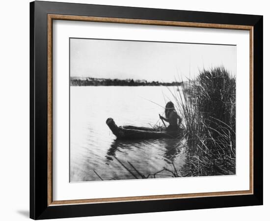 Pomo Indian Poling His Boat Made of Tule Rushes Through Shallows of Clear Lake, Northen California-Edward S^ Curtis-Framed Photographic Print