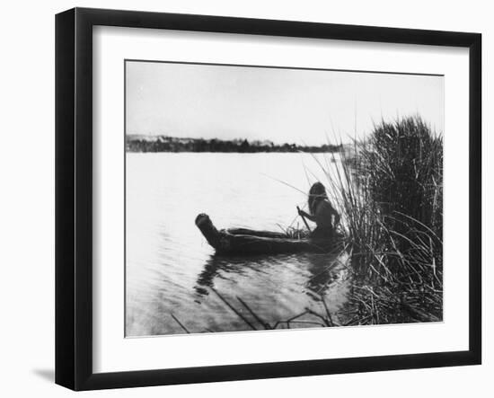 Pomo Indian Poling His Boat Made of Tule Rushes Through Shallows of Clear Lake, Northen California-Edward S^ Curtis-Framed Photographic Print