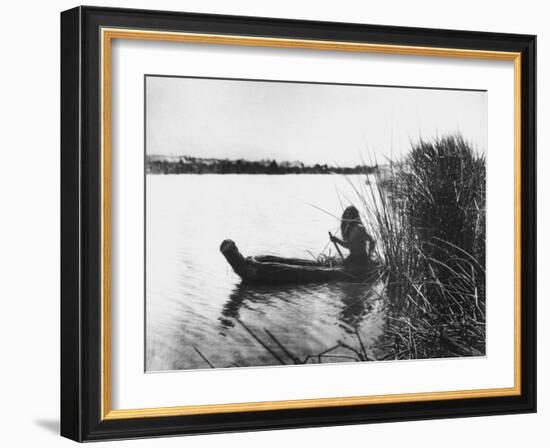 Pomo Indian Poling His Boat Made of Tule Rushes Through Shallows of Clear Lake, Northen California-Edward S^ Curtis-Framed Photographic Print