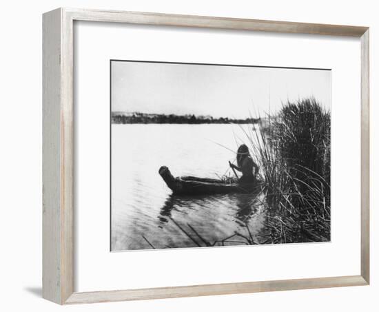 Pomo Indian Poling His Boat Made of Tule Rushes Through Shallows of Clear Lake, Northen California-Edward S^ Curtis-Framed Photographic Print