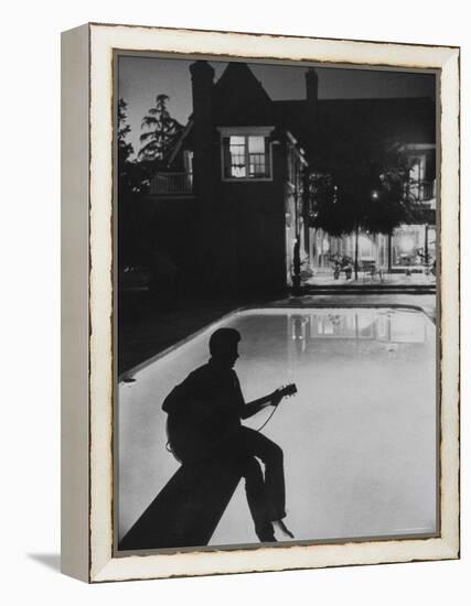 Pop Singer Ricky Nelson Sitting on Diving Board of Family Swimming Pool-Hank Walker-Framed Premier Image Canvas