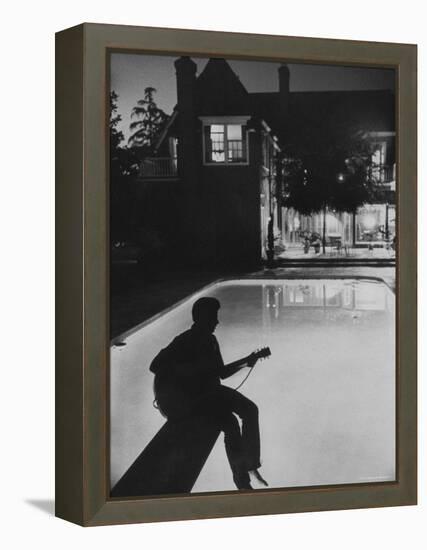 Pop Singer Ricky Nelson Sitting on Diving Board of Family Swimming Pool-Hank Walker-Framed Premier Image Canvas