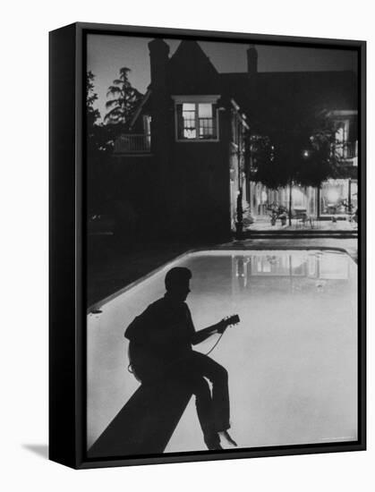 Pop Singer Ricky Nelson Sitting on Diving Board of Family Swimming Pool-Hank Walker-Framed Premier Image Canvas