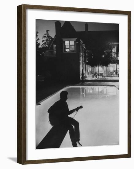 Pop Singer Ricky Nelson Sitting on Diving Board of Family Swimming Pool-Hank Walker-Framed Premium Photographic Print