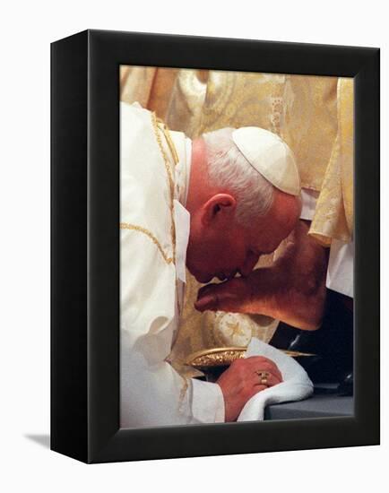 Pope John Paul II Kisses the Foot of a Clergyman-null-Framed Premier Image Canvas