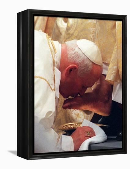 Pope John Paul II Kisses the Foot of a Clergyman-null-Framed Premier Image Canvas