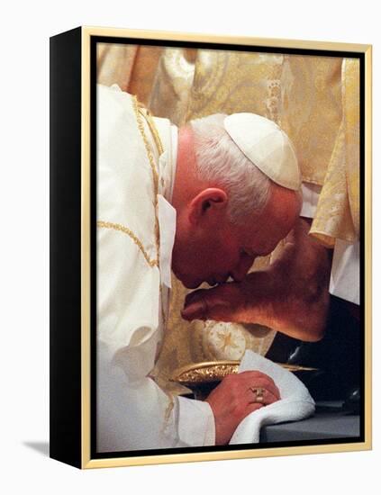 Pope John Paul II Kisses the Foot of a Clergyman-null-Framed Premier Image Canvas