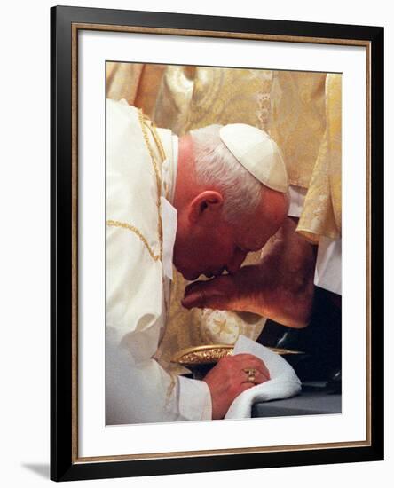 Pope John Paul II Kisses the Foot of a Clergyman-null-Framed Photographic Print