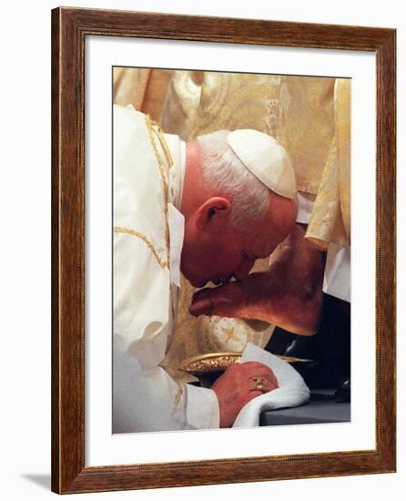 Pope John Paul II Kisses the Foot of a Clergyman-null-Framed Photographic Print