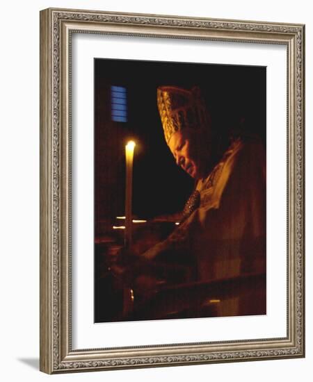 Pope John Paul II Prays Before a Candle at the Beginning of an Holy Easter Vigil Mass-null-Framed Photographic Print