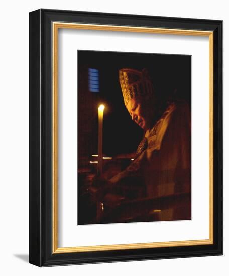Pope John Paul II Prays Before a Candle at the Beginning of an Holy Easter Vigil Mass-null-Framed Photographic Print