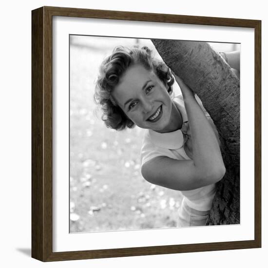 Portrait of American Actress Debbie Reynolds as She Poses Behind a Tree, 1950-Loomis Dean-Framed Photographic Print