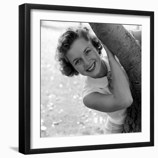 Portrait of American Actress Debbie Reynolds as She Poses Behind a Tree, 1950-Loomis Dean-Framed Photographic Print