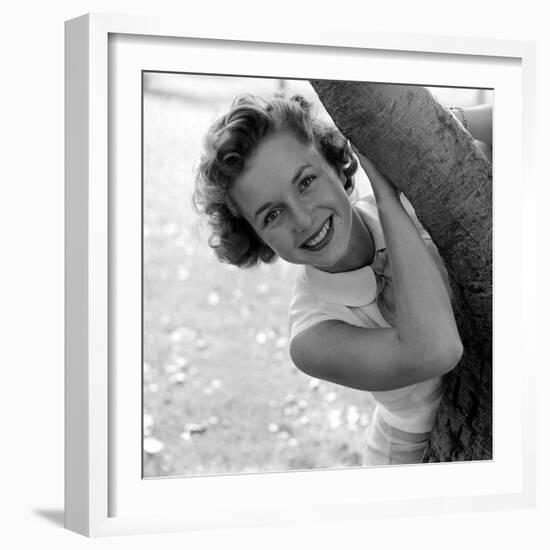 Portrait of American Actress Debbie Reynolds as She Poses Behind a Tree, 1950-Loomis Dean-Framed Photographic Print