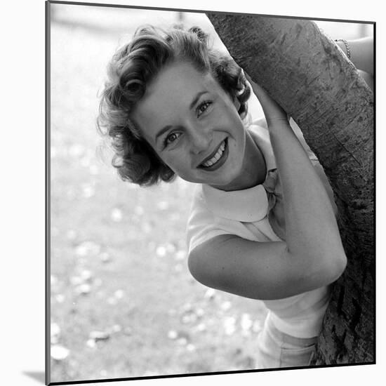 Portrait of American Actress Debbie Reynolds as She Poses Behind a Tree, 1950-Loomis Dean-Mounted Photographic Print