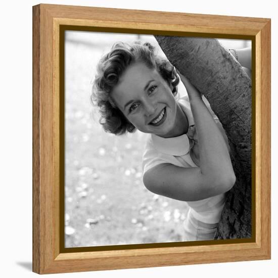 Portrait of American Actress Debbie Reynolds as She Poses Behind a Tree, 1950-Loomis Dean-Framed Premier Image Canvas