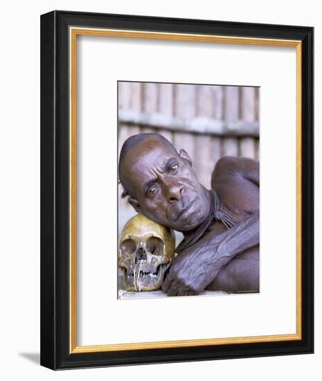 Portrait of an Asmat Tribesman Leaning on a Human Skull, Irian Jaya, Indonesia-Claire Leimbach-Framed Photographic Print