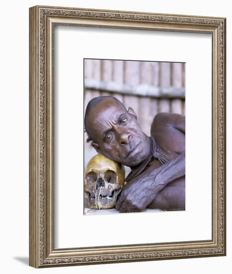 Portrait of an Asmat Tribesman Leaning on a Human Skull, Irian Jaya, Indonesia-Claire Leimbach-Framed Photographic Print