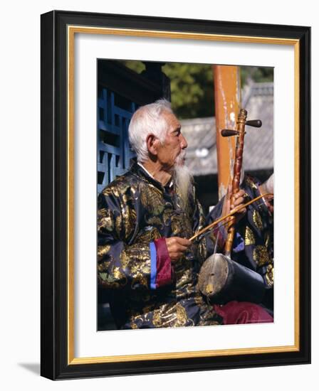 Portrait of an Elderly Musician from the Naxi Orchestra Practising by the Black Dragon Pool, China-Doug Traverso-Framed Photographic Print