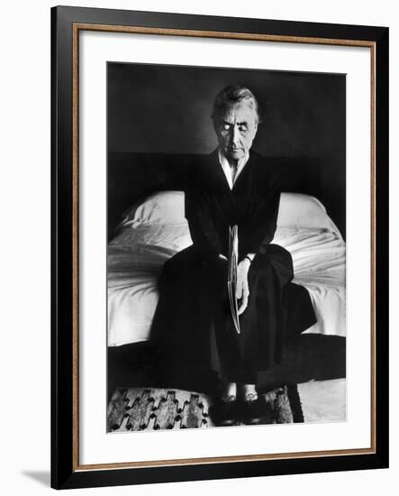 Portrait of Artist Georgia O'Keeffe Holding a Book by Leonard Baskinin Her Bedroom-John Loengard-Framed Premium Photographic Print