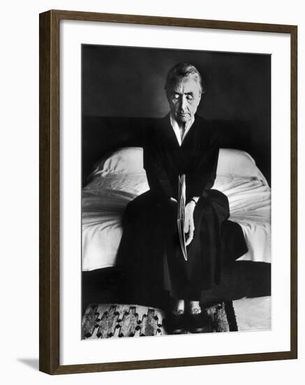 Portrait of Artist Georgia O'Keeffe Holding a Book by Leonard Baskinin Her Bedroom-John Loengard-Framed Premium Photographic Print