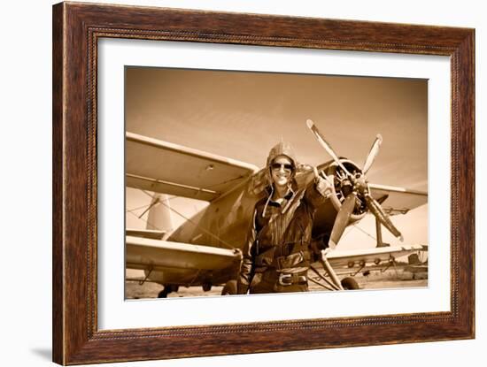 Portrait of Beautiful Female Pilot with Plane Behind. Sepia Photo.-Aleksandar Todorovic-Framed Art Print