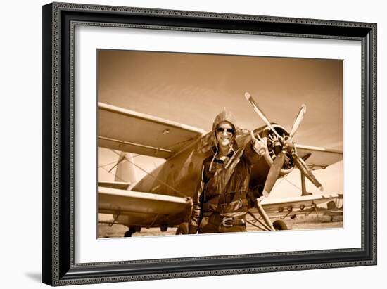 Portrait of Beautiful Female Pilot with Plane Behind. Sepia Photo.-Aleksandar Todorovic-Framed Art Print