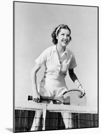 Portrait of Female Tennis Player at the Net-null-Mounted Photo