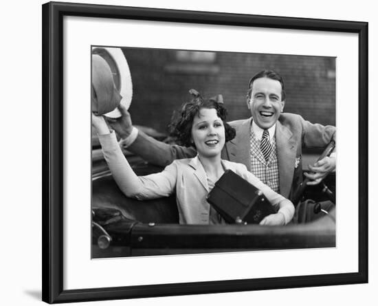 Portrait of Happy Couple Waving in Car-null-Framed Photo