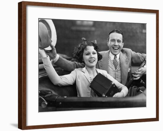 Portrait of Happy Couple Waving in Car-null-Framed Photo