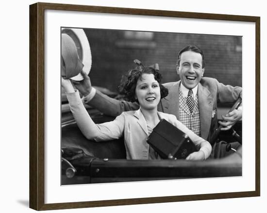 Portrait of Happy Couple Waving in Car-null-Framed Photo