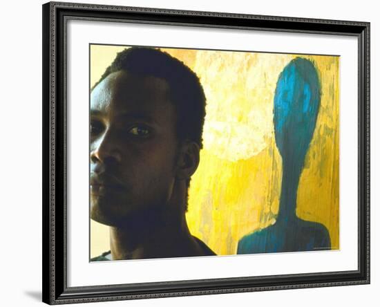 Portrait of Nigerian Artist Erhabor Emokpae Standing Next to One of His Colorful Paintings-Carlo Bavagnoli-Framed Premium Photographic Print