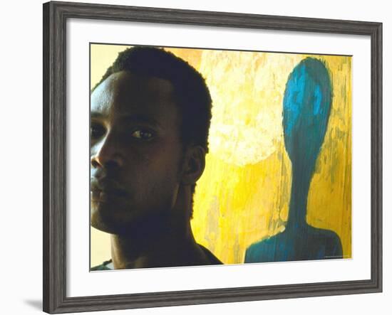 Portrait of Nigerian Artist Erhabor Emokpae Standing Next to One of His Colorful Paintings-Carlo Bavagnoli-Framed Premium Photographic Print