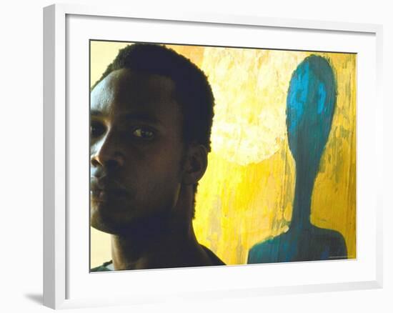 Portrait of Nigerian Artist Erhabor Emokpae Standing Next to One of His Colorful Paintings-Carlo Bavagnoli-Framed Premium Photographic Print